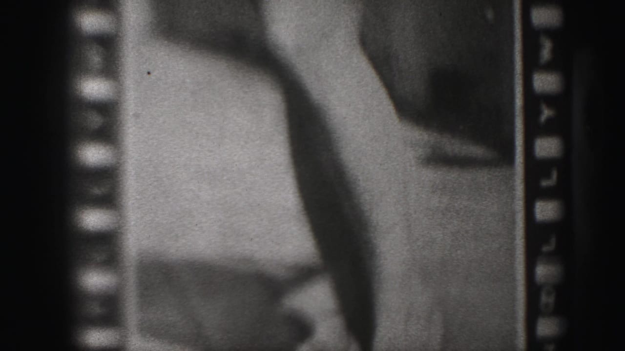 Closer poster detail showing legs, a bent arm or shadowed form, and film sprocket borders.