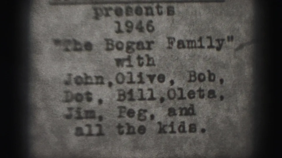 Soft 8mm frame of the 1946 Bogar Family title card, showing names including John, Olive, Bob, Dot, Bill, Oleta, Jim, and Peg.