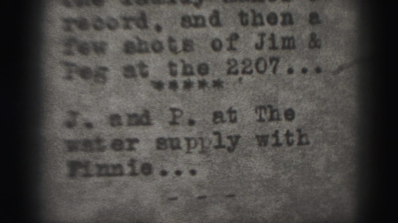 Blurred typewritten title-card text on grainy black-and-white film.