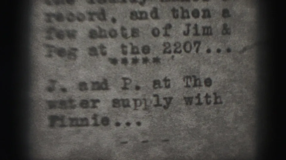 Soft, grainy 8mm frame showing a close-up of partially readable typewritten text from a 1946 Harrisburg home movie.