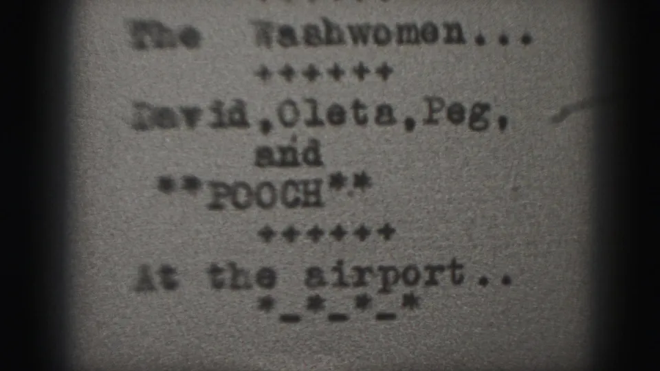 Close-up 8mm frame of a typewritten title card from the Harrisburg home movie, with airport wording and repeated names visible.
