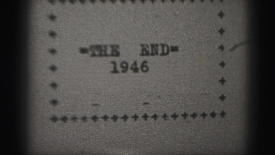 Black-and-white 1946 home-movie end title card, slightly shifted in the gate, with dotted border and visible 8mm texture.