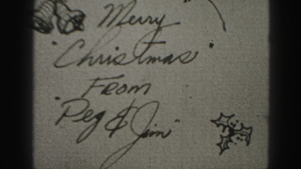 Final 1946 home-movie greeting card frame, showing Merry Christmas From Peg & Jim in cursive with small holly illustration.