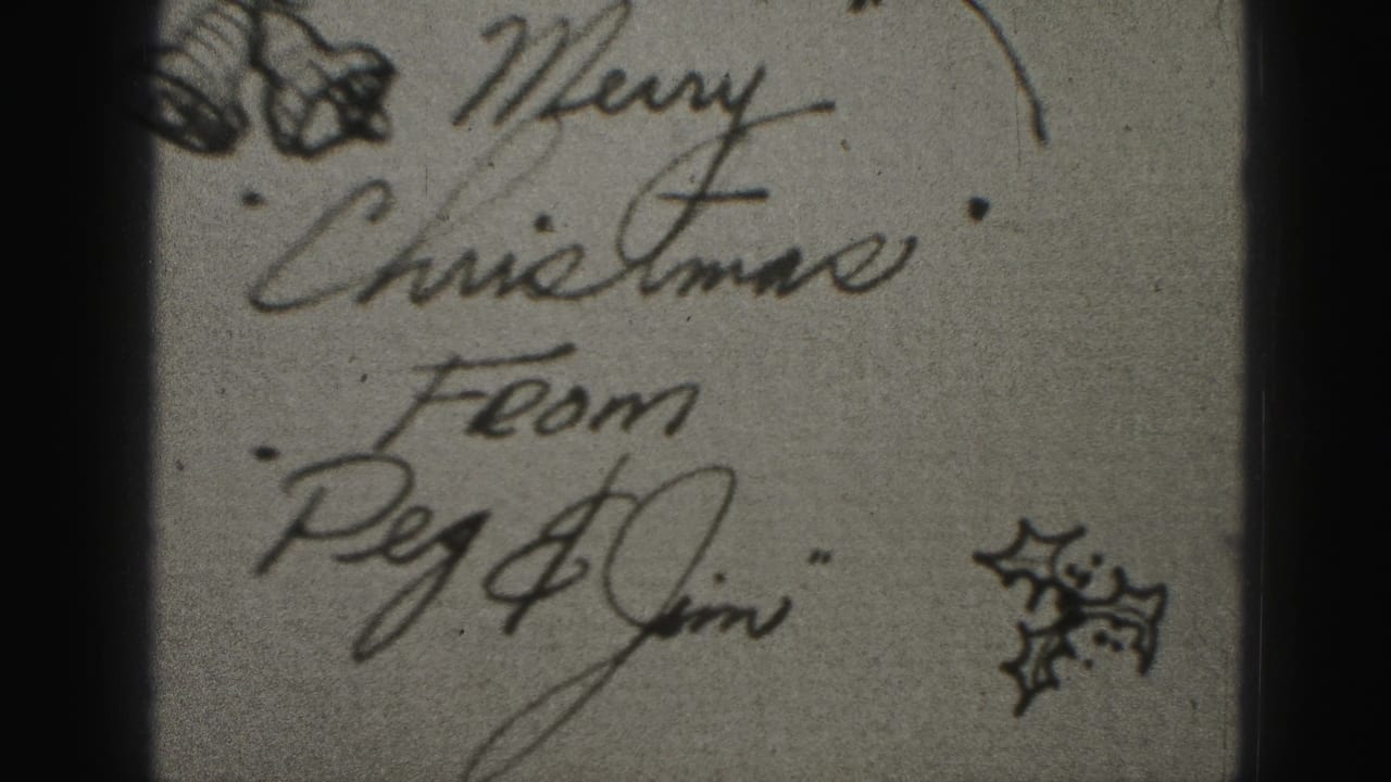 Handwritten Christmas card with festive drawings and partial dark film edge.