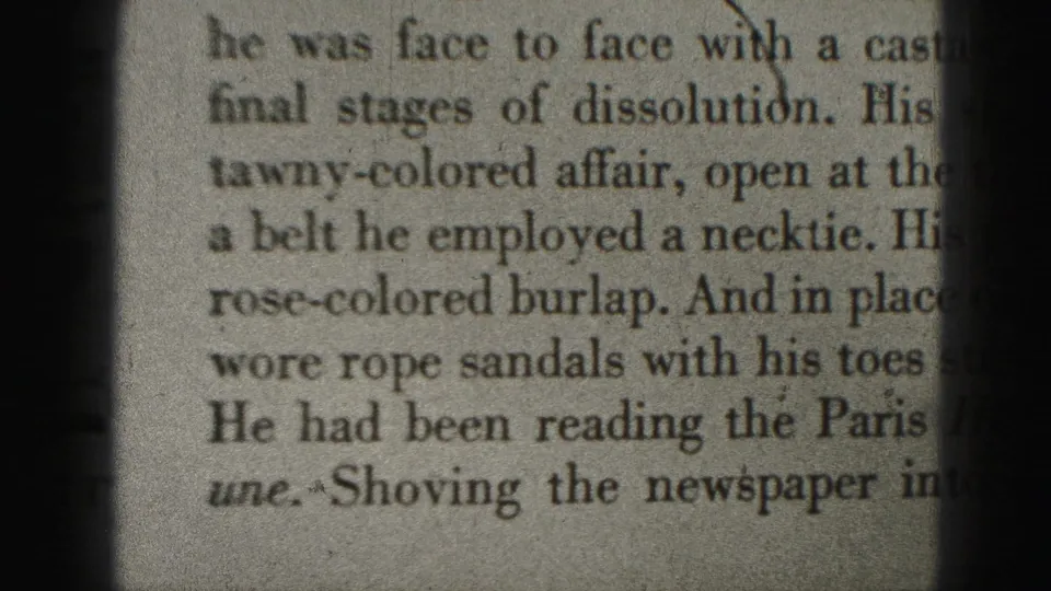 Close-up of a newspaper clipping with readable fragments about clothing and sandals, framed by dark 8mm gate edges.
