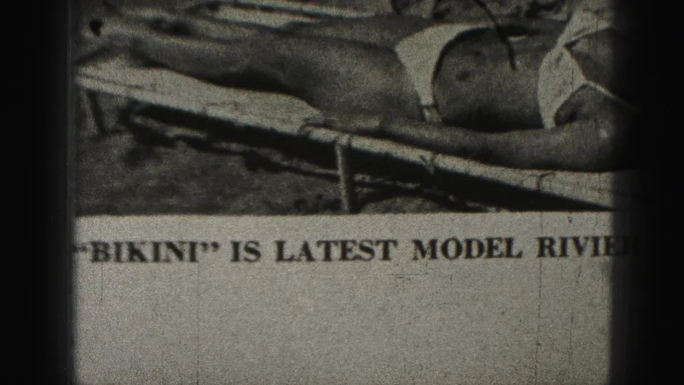 1946 Harrisburg 8mm frame showing a newspaper article with partial text mentioning bikini and a Riviera swim suit.