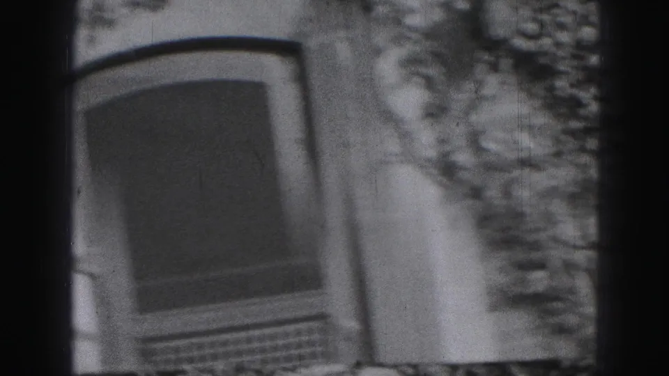 1946 Harrisburg home-movie frame showing a soft-focus arched window beside ivy-covered stonework.