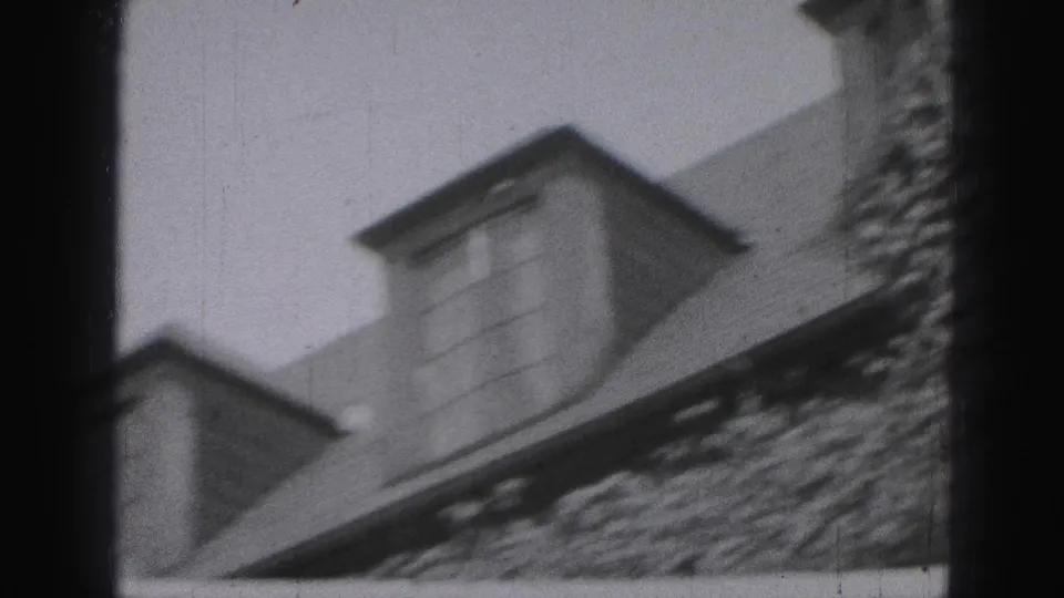 1946 Harrisburg frame showing a dormer window, sloped roof, and ivy-covered stone exterior in black and white.