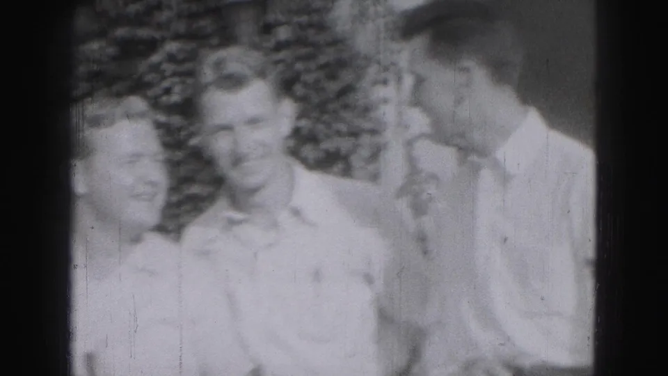 Three young men in light shirts appear to pose outdoors in Harrisburg, Pennsylvania, in 1946 home-movie footage.