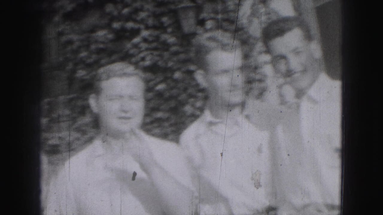 Three young men face the camera, with one adjusting his collar or neckline.