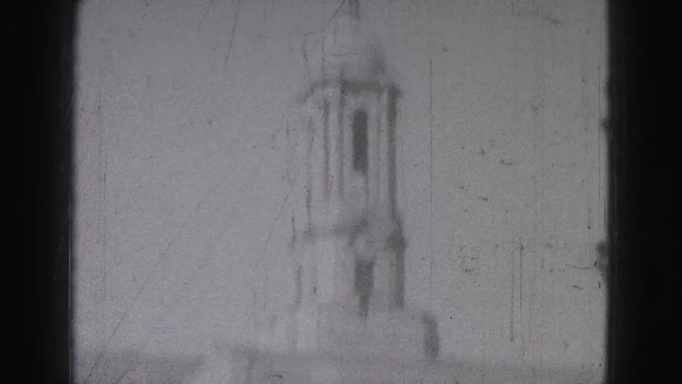 The clip ends with a soft 8mm view of a distant tower-like structure, possibly near Harrisburg but not identifiable from the frame alone.