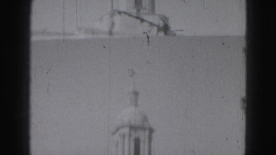 A soft 8mm frame of the Harrisburg public building tower and upper roofline, partially bordered by dark vertical edges.