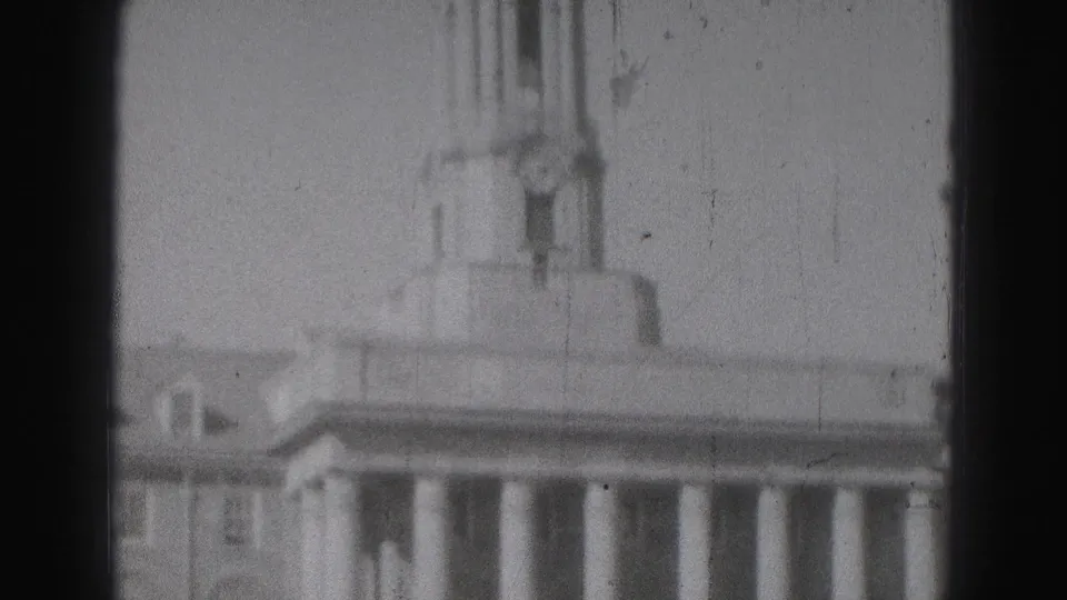 Black-and-white 8mm view of the Harrisburg civic building, with columns below and a small domed tower above the roof.