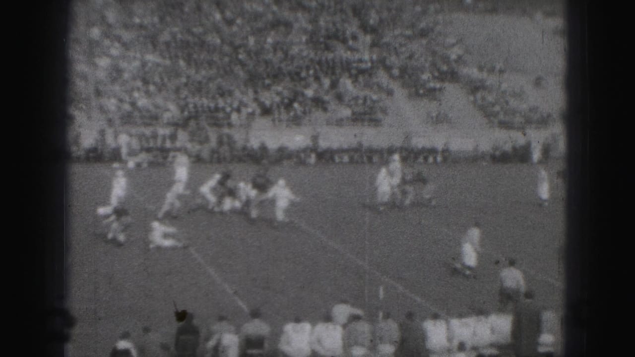 Harrisburg, Pennsylvania 1946 home-movie frame showing football players on the field with spectators filling the stadium stands.