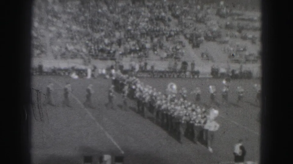 1946 Harrisburg footage shows the marching band advancing across the field, with musicians and a packed stadium crowd visible.