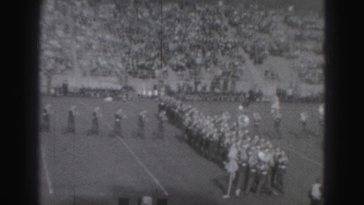 1946 Harrisburg football game view showing marching band lines on the field and spectators filling the stands.