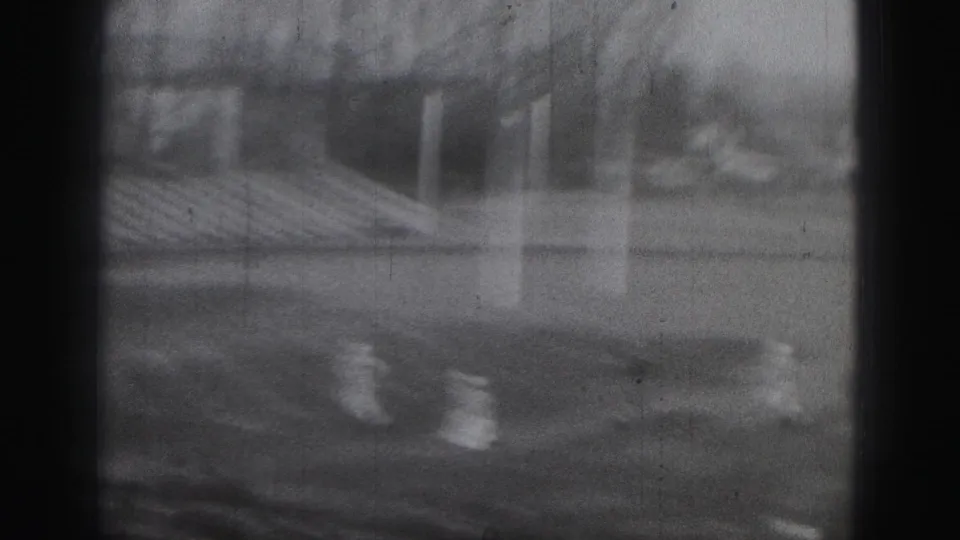 Rugby players move across the field in a soft 8mm frame, with spectator seating visible in the Harrisburg sports setting.