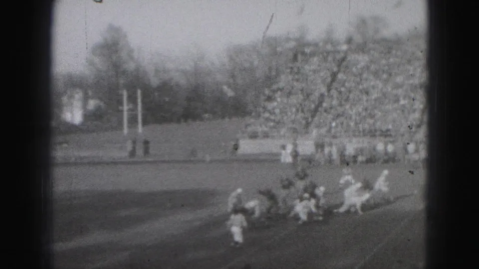 1946 Harrisburg sports footage shows players converging on the field with packed stands in the background.