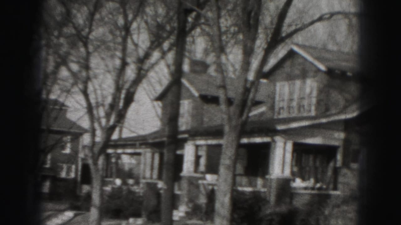 1946 Harrisburg neighborhood view with leafless trees and porch-front houses seen in grainy black-and-white 8mm footage.