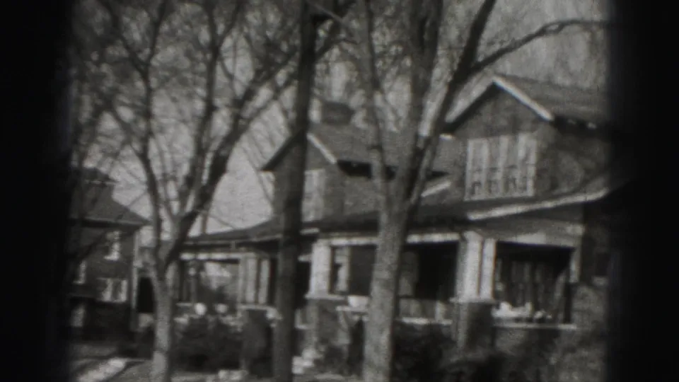 1946 Harrisburg neighborhood view with leafless trees and porch-front houses seen in grainy black-and-white 8mm footage.