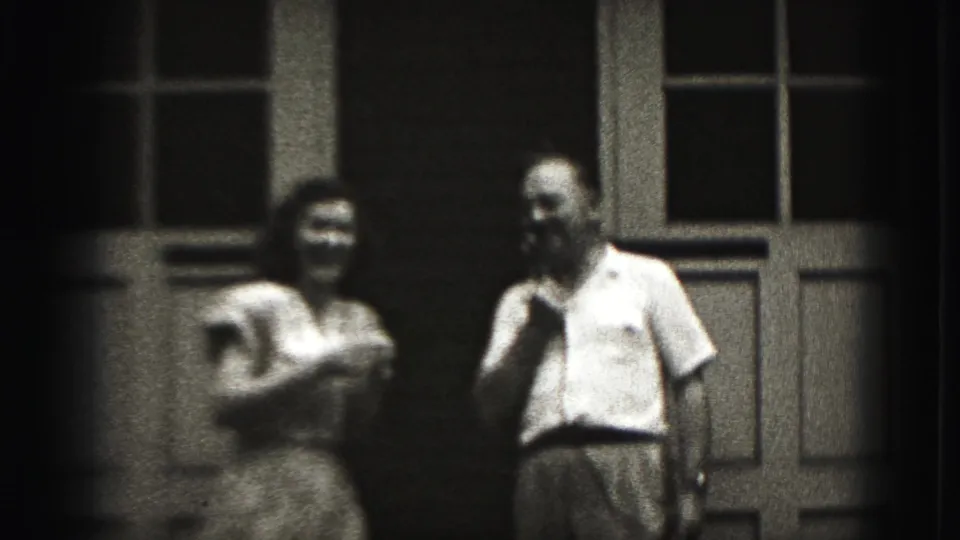 The woman gestures animatedly as the man smiles beside her in this 1946 New Cumberland outdoor home-movie frame.