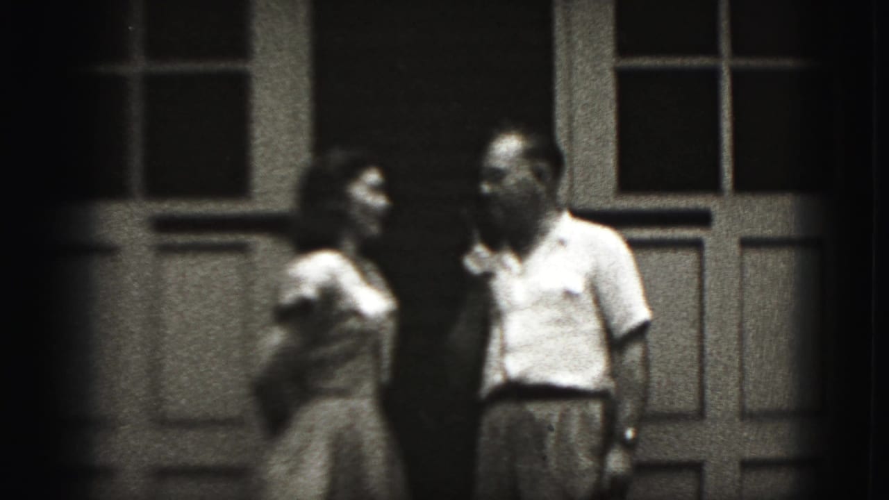 The couple turns toward one another with the microphone between them outside a New Cumberland building in 1946 footage.