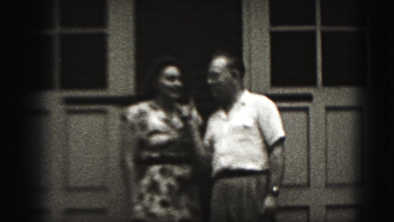 Couple standing by a doorway as the woman faces the man.