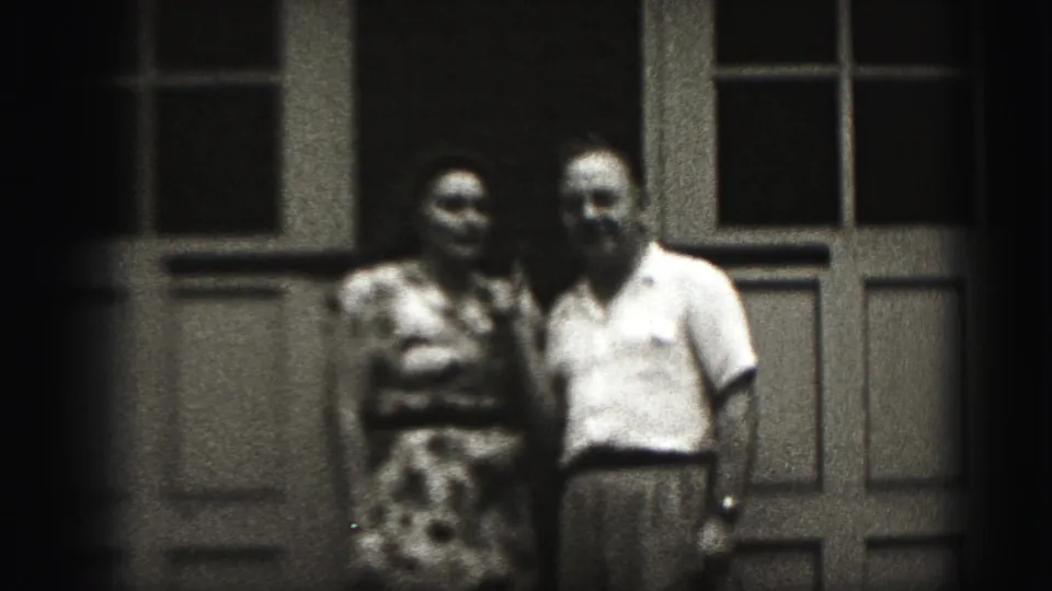The couple stands side by side again, facing the camera outside the paneled doorway in New Cumberland, Pennsylvania.