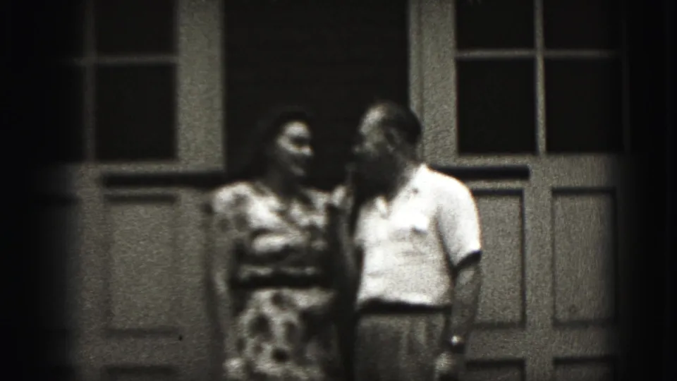 The adult couple turns toward one another outside the building in the 1946 New Cumberland 8mm scene.