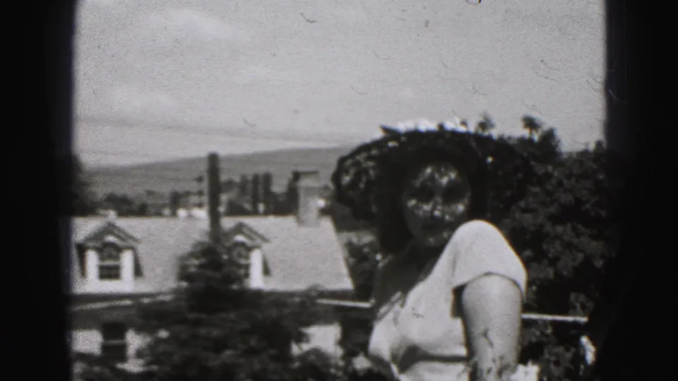 Woman in a wide-brimmed hat poses outdoors in New Cumberland, Pennsylvania, in 1946 home-movie footage.
