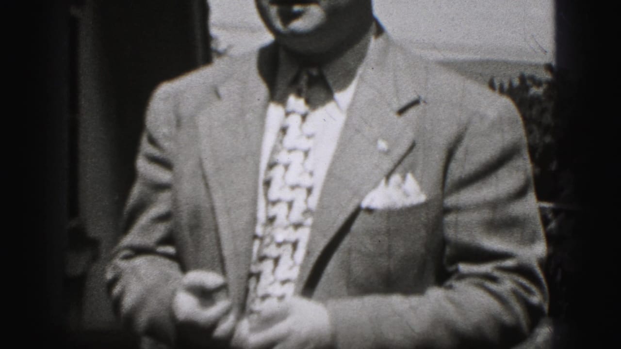 In 1946 New Cumberland footage, a suited man faces the camera in a tightly cropped outdoor home-movie frame.