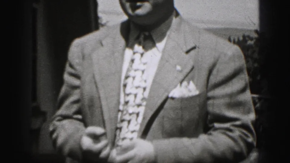 In 1946 New Cumberland footage, a suited man faces the camera in a tightly cropped outdoor home-movie frame.