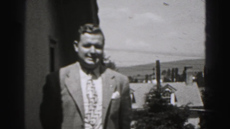 Adult man in a suit smiles toward the camera on a porch or balcony in New Cumberland, Pennsylvania.