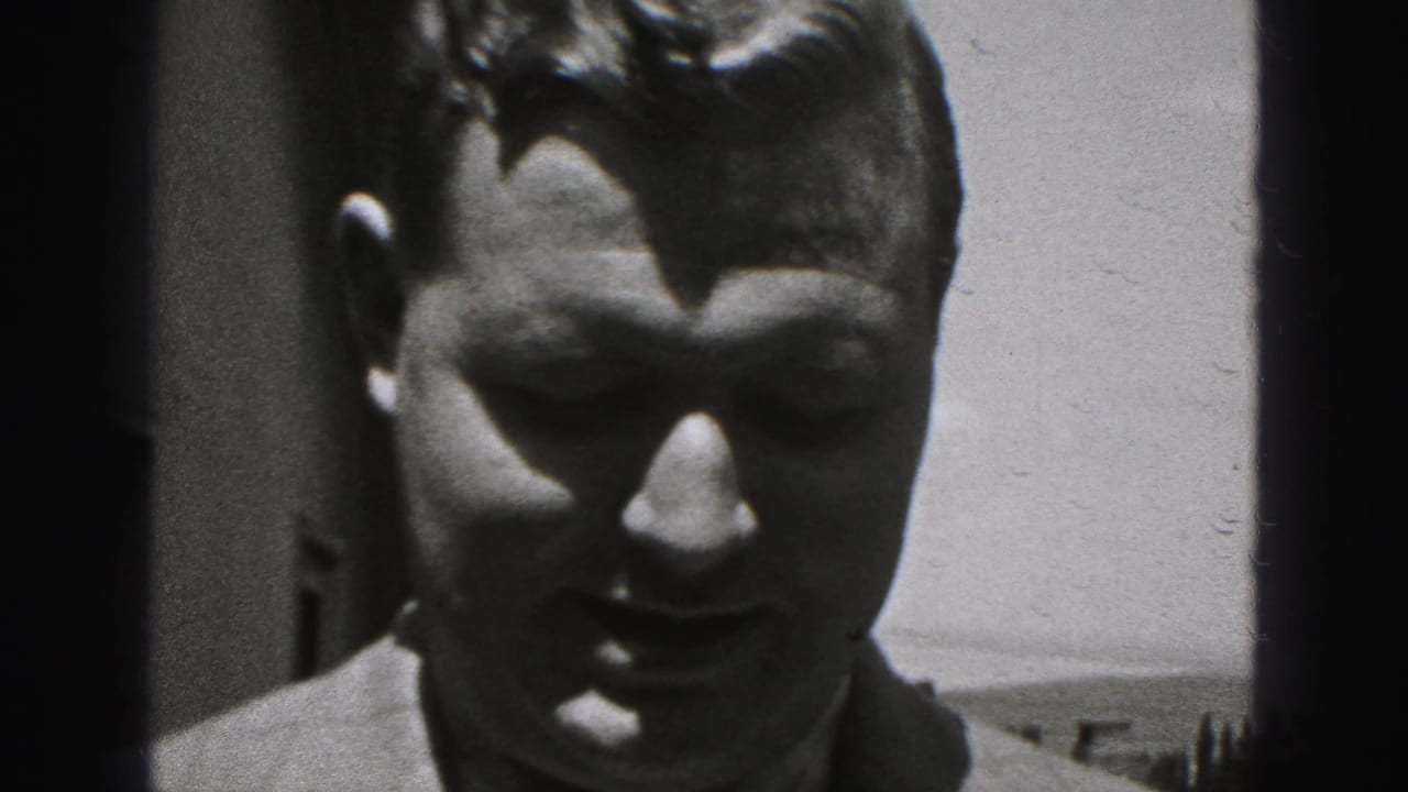 Close view of a man in dark shadow facing the camera outdoors.