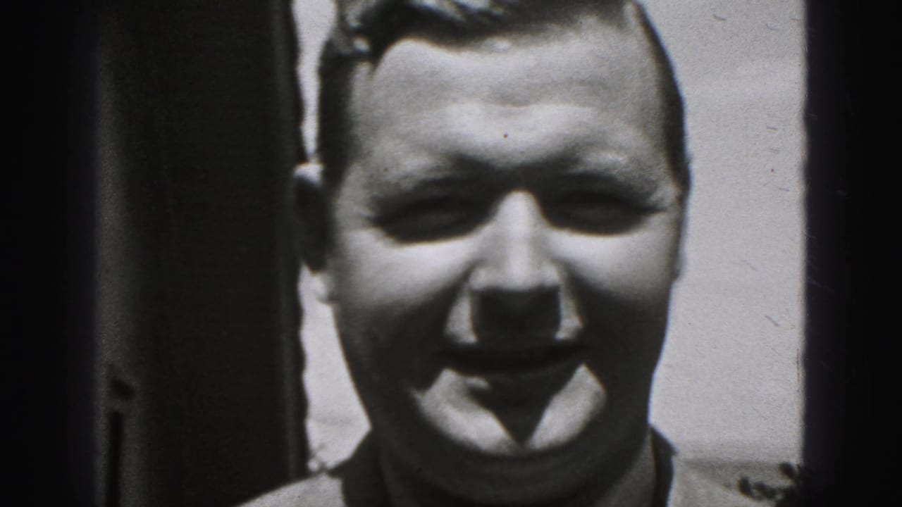Smiling adult man faces the camera in a black-and-white 8mm frame from the 1946 New Cumberland home movie.
