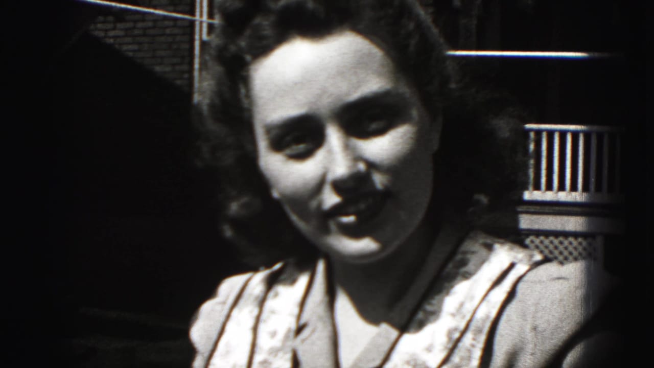 The woman faces the camera more directly and smiles in this 1946 Pennsylvania home-movie frame.