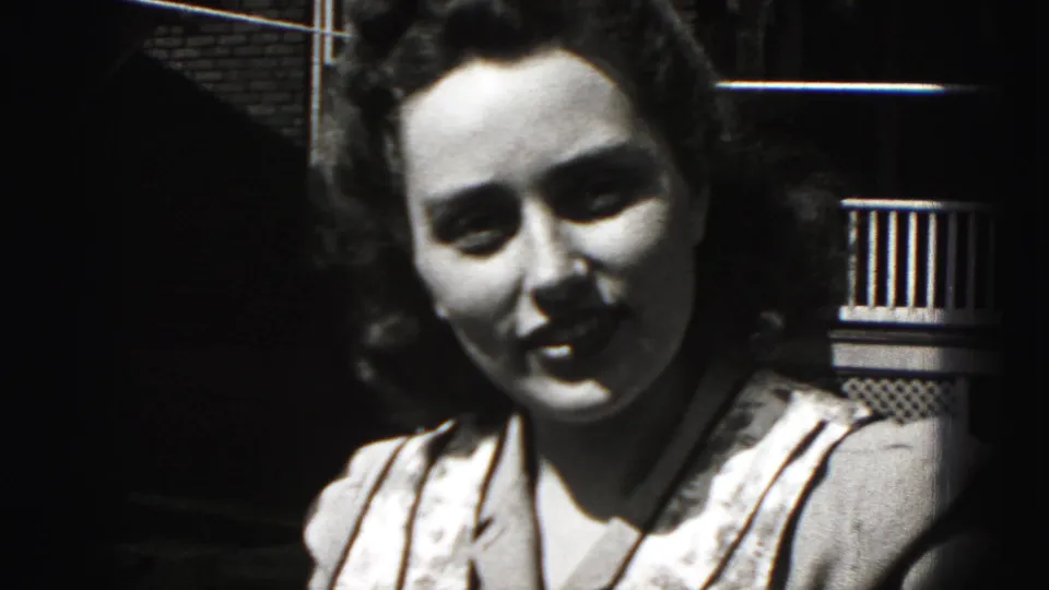 The woman faces the camera more directly and smiles in this 1946 Pennsylvania home-movie frame.
