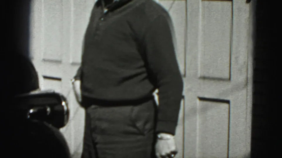 In 1946 New Cumberland home-movie footage, an adult man is partly cropped while standing by a paneled garage door.