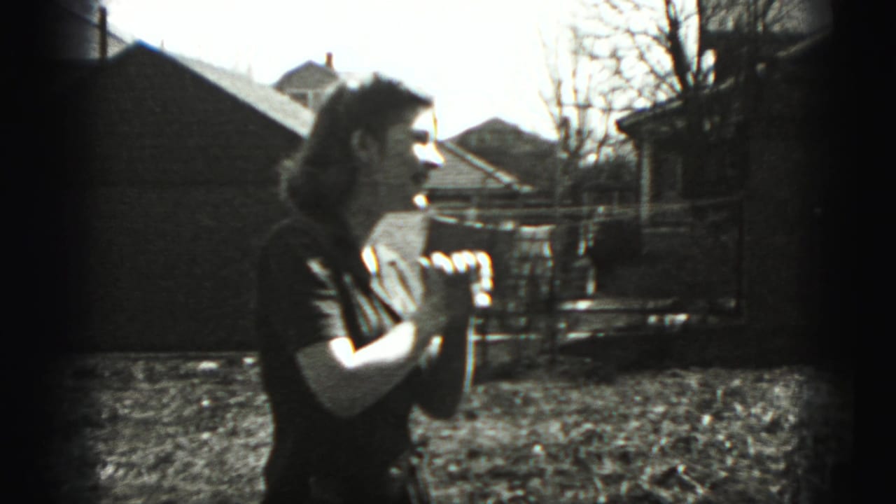Woman in profile holds her hands near her chest in a backyard.