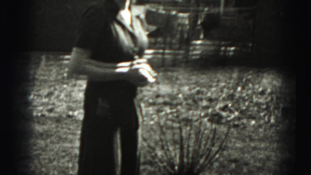 Woman standing outdoors in dark clothing, partly cropped by the frame edge.