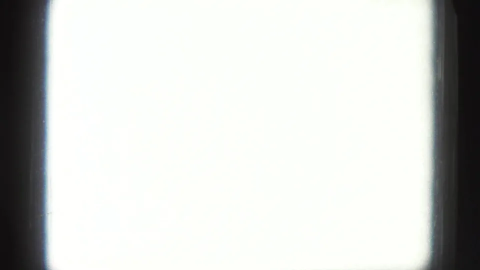 An overexposed section of the 8mm reel shows a bright blank field bordered by dark film edges.
