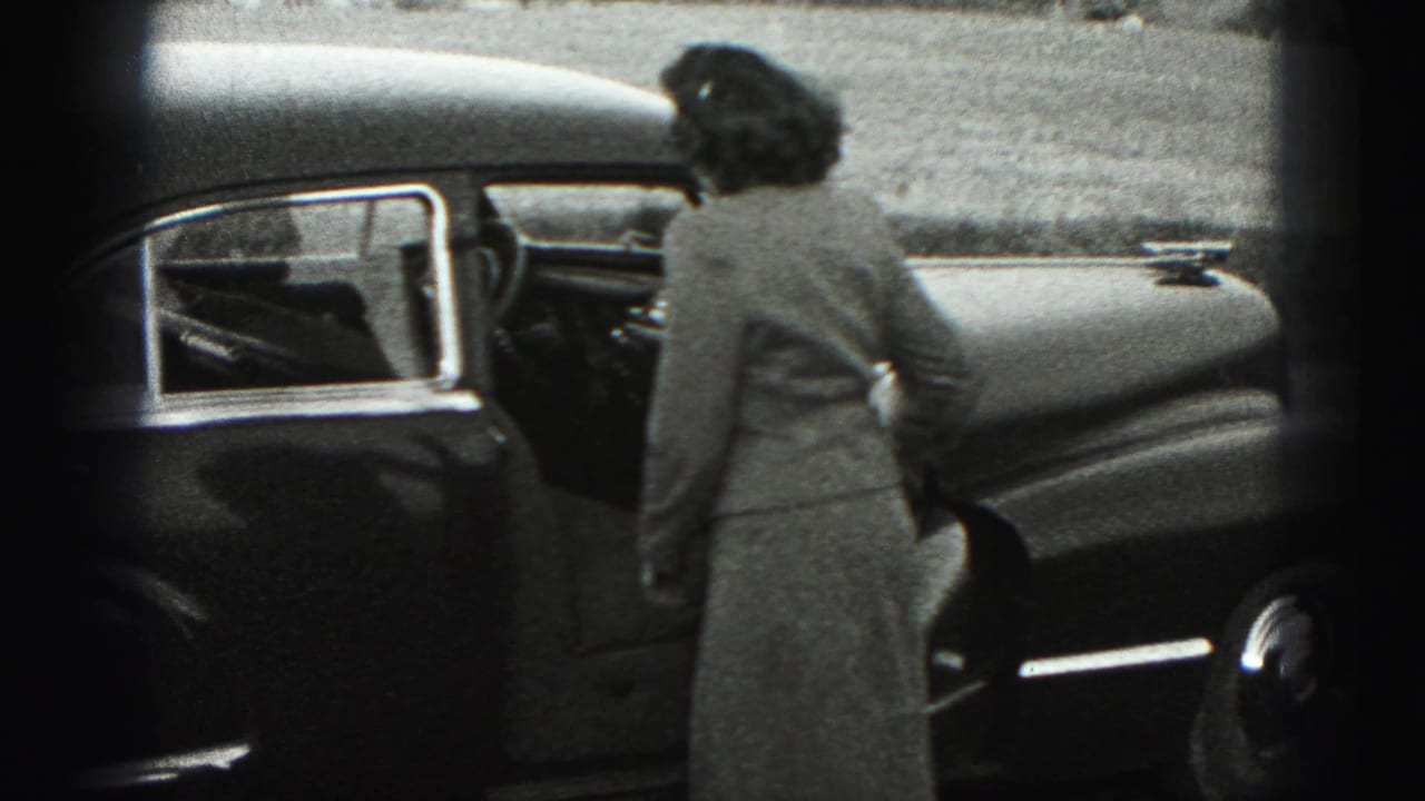 The woman faces the sedan, seen from behind, as she reaches the driver-side door in New Cumberland, Pennsylvania.