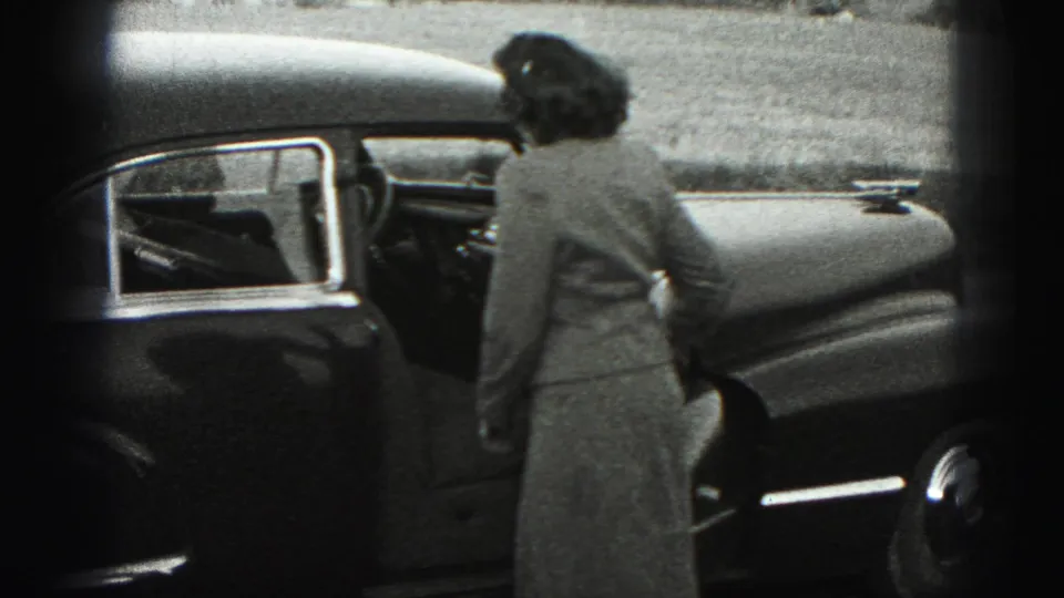 The woman faces the sedan, seen from behind, as she reaches the driver-side door in New Cumberland, Pennsylvania.