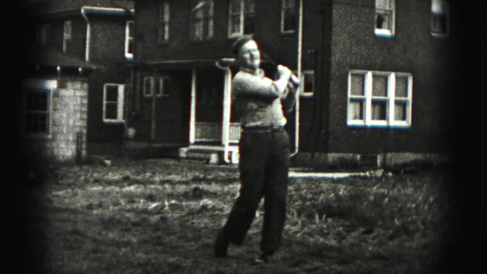 In New Cumberland, Pennsylvania, a man stands with a golf club in a front yard before a brick home in 1946 home-movie footage.