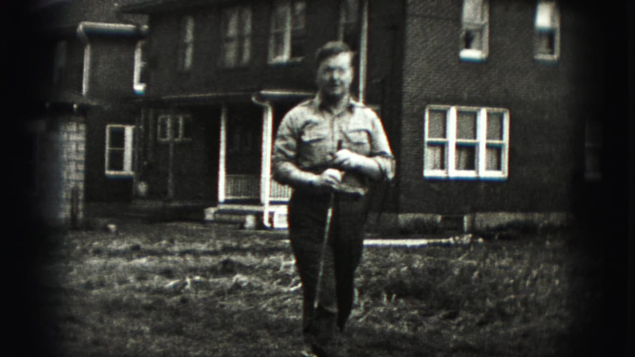 The man stands closer to the camera with his golf club in hand, framed by a grassy yard and brick residential exterior.