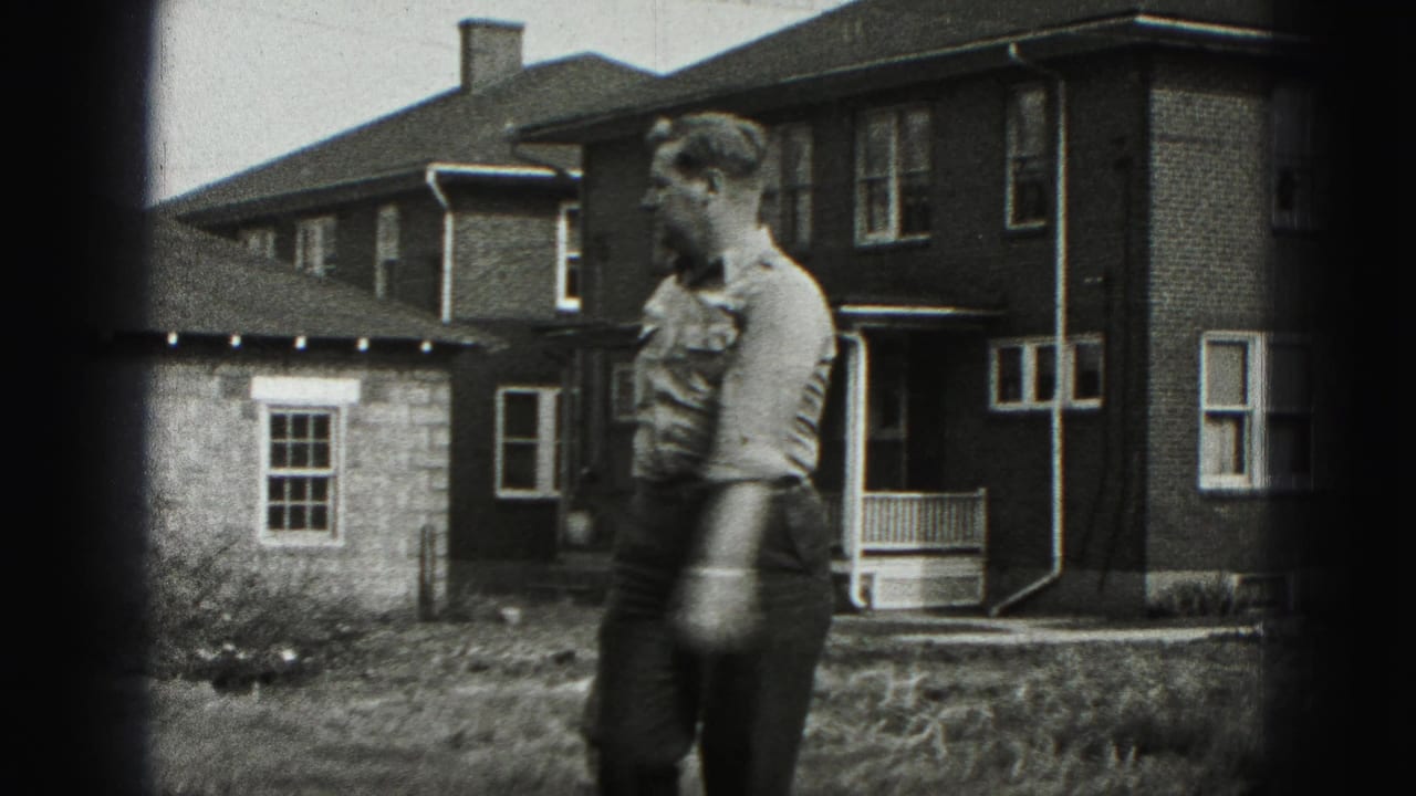 The man moves across the residential yard with the golf club, captured in grainy 8mm footage from 1946 New Cumberland.
