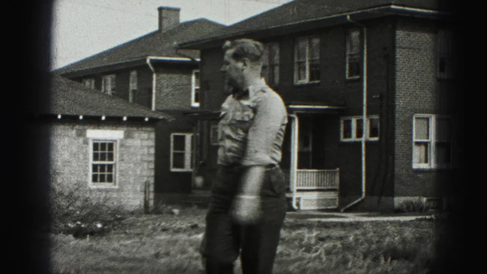 The man moves across the residential yard with the golf club, captured in grainy 8mm footage from 1946 New Cumberland.