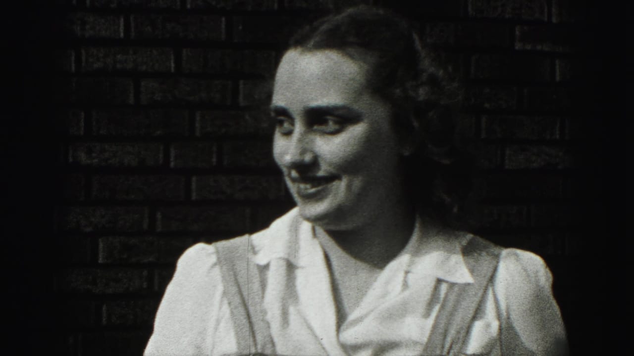 The young woman turns slightly and laughs beside the brick wall, giving the 1946 New Cumberland home movie a candid finish.