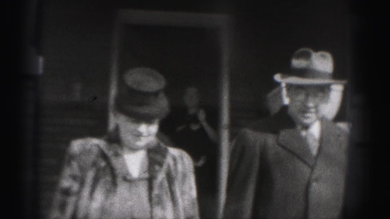 The couple turns toward the camera in New Cumberland, Pennsylvania, with period hats and coats visible in the 8mm frame.