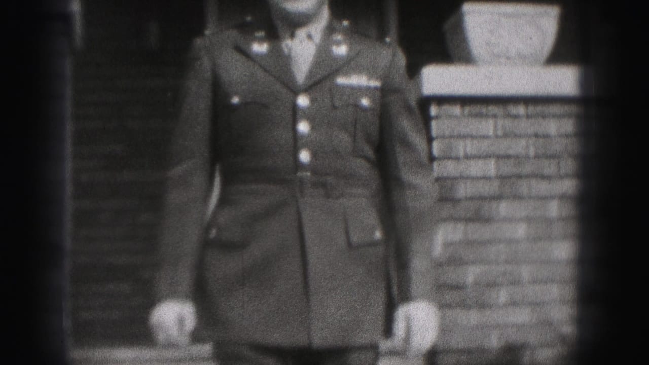 A closer black-and-white frame shows the uniform jacket and brick porch detail as the man nears the camera.